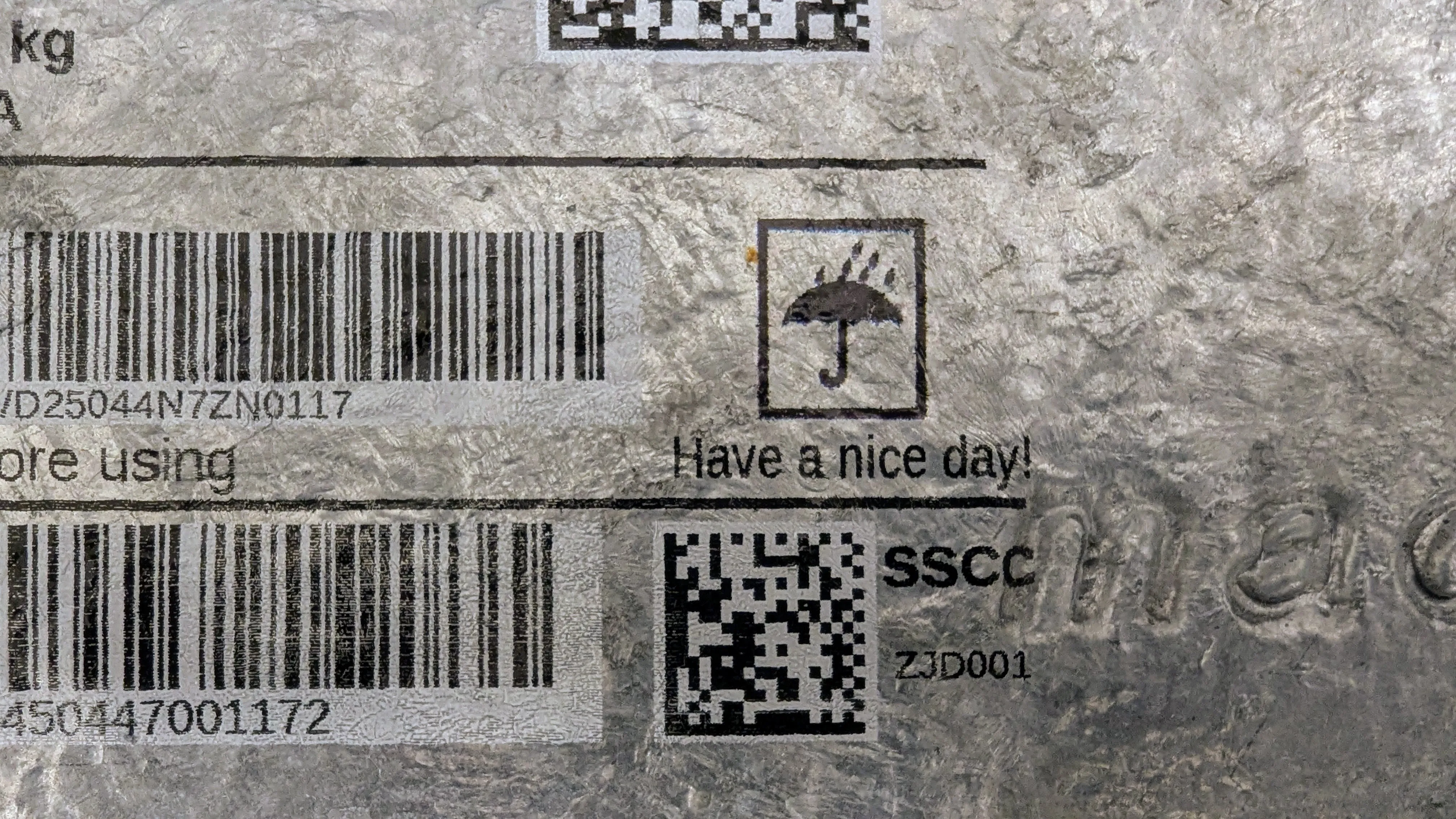 Galvaniserad metallyta med streckkoder, DataMatrix-kod och hanteringssymbol tryckta direkt på metallen